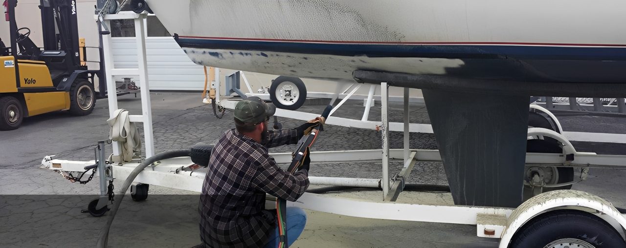 Boat maintenance in progress with pressure washer